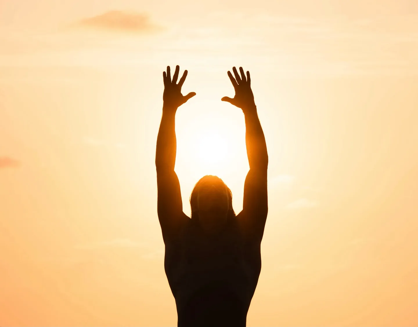 Christian raising his arms toward the sun
